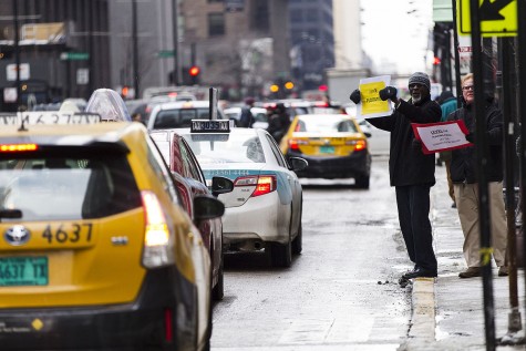 New York Uber Drivers holding signs refusing to take the fare cuts. (Credit: Scott M. Liebenson)