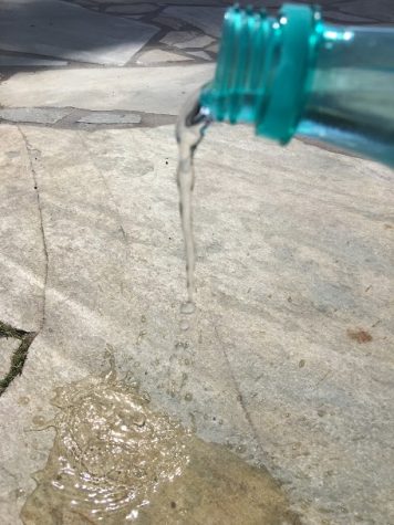 Water bottle spills symbolizing water crisis in India.