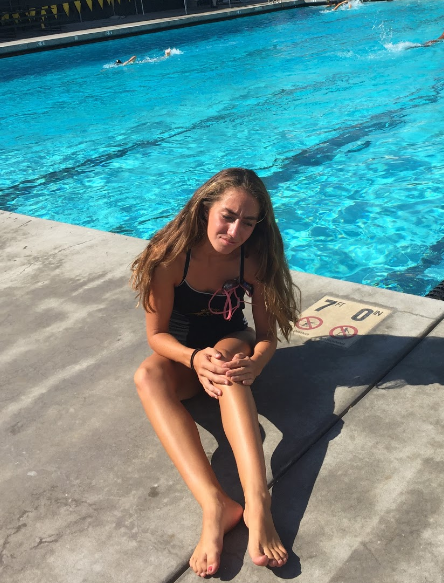 Courtesy of Sammie Discher
Water polo player, Annaliese, holding her knee in pain.