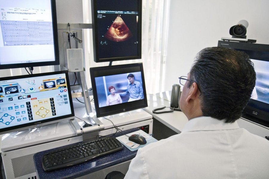 A cardiologist at a hospital in Mexico is in a pre-surgery consultation with a patient and her doctor, who are in California. Patient information such as charts and scans can be exchanged in seconds, and physicians who are geographically isolated can now hear and see each other well during consultations.