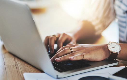 Shot of an unrecognizable businesswoman working on a laptop in her office