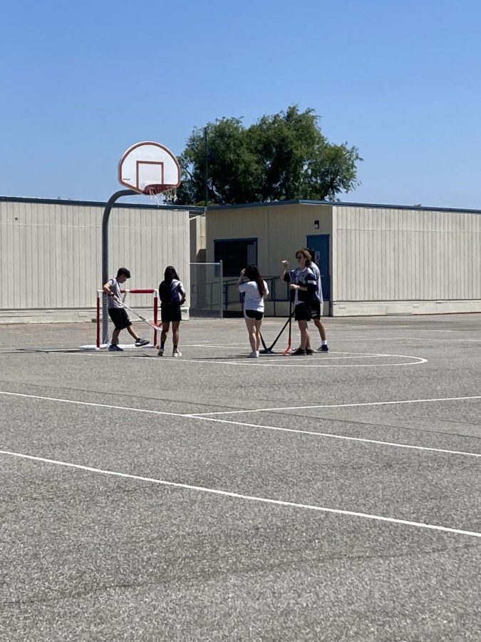 Students play Street Hockey during PE.