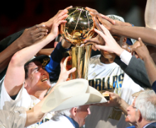 The 2011 Champion Dallas Mavericks pose with their first Larry OBrien Trophy. 