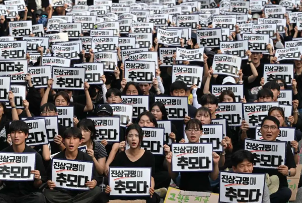 Protests in South Korea demand rights and protection for teachers. The signs say, Finding out the truth is a tribute. 
