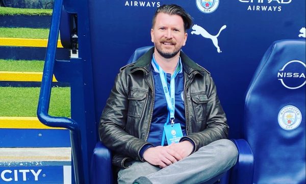 Mr. Jackson sits in City Manager Pep Guardiolas chair at the Etihad Stadium in Manchester. 