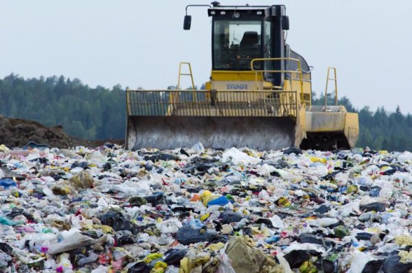 Accumulating clothes waste in landfills due to fast fashion.
