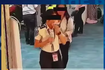 Screenshot of the CCTV footage that shows an airport security officer in the Philippines attempting to swallow a passengers money.