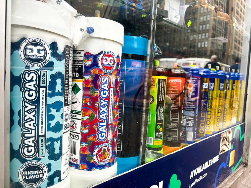 Shelves stocked with Galaxy Gas in a smoke shop.