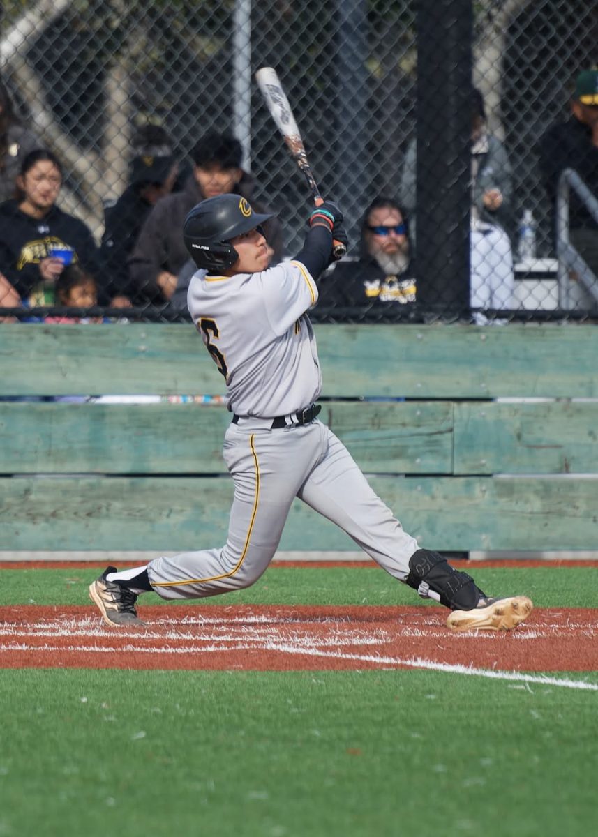 Isaiah Mendoza takes a swing during a baseball game. 