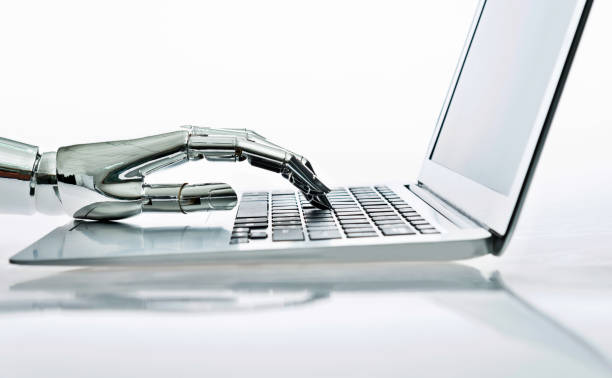Robot's hand typing on keyboard.