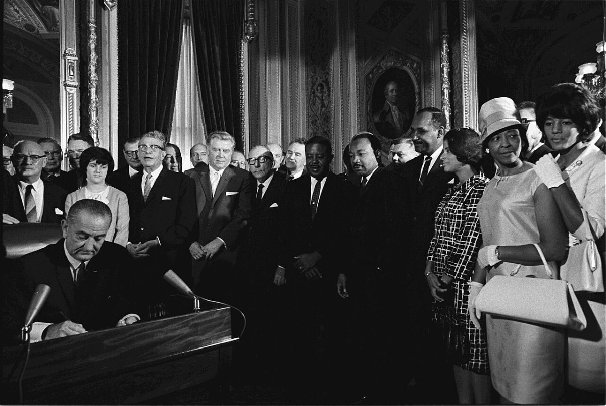 President Lyndon B. Johnson signs the Voting Rights Act of 1965.