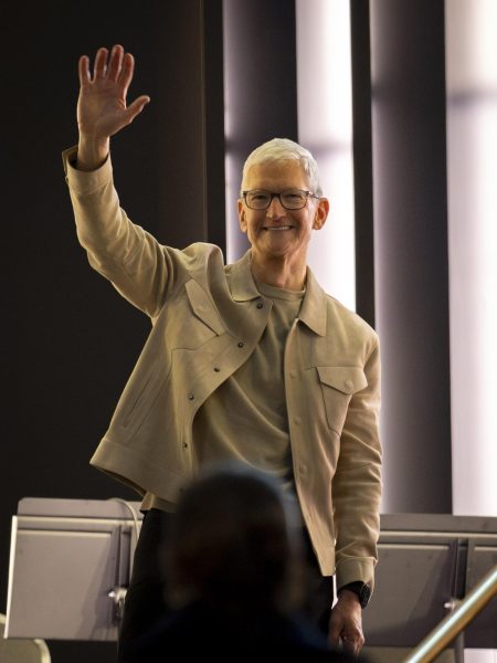 Tim Cook waving to attendees at Apple's 50th Anniversary kickoff event in New York.